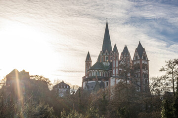A cathedral in a city, beautifully illuminated at dusk. Morning in Limburg, Hesse
