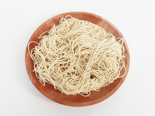 raw ramen noodle in wood plate isolated on white background. fresh egg ramen noodle isolated on white background. Japanese food ramen noodle isolated on white background