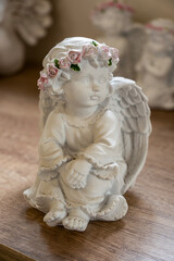 White plaster angel figurine on table