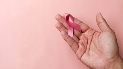 Pink Breast Cancer Awareness Ribbon. pink ribbon with pastel color background. Breast cancer awareness and October Pink day, world cancer day