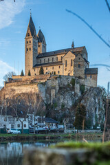 A winter landscape shot at sunrise. Plenty of nature and a large church on a rock. The former collegiate church of St. Lubentius Limburger, Dietkirchen, Hesse