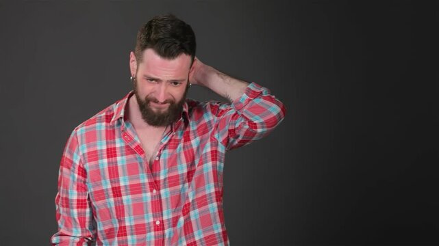 Young Caucasian man showing signs of stress and discomfort