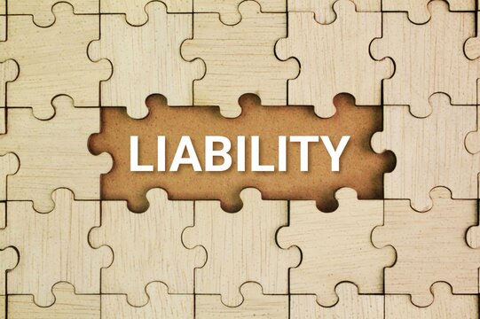 Wooden puzzle with the word Liability. the state of being legally responsible for something. the concept of being legally responsible for something