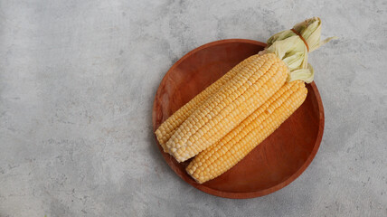 Fresh yellow corn isolated on grey background