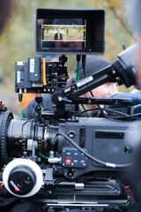 Fototapeta premium Capturing the Moment: A Professional Film Camera in Action During a Shoot with a Framed Subject on Screen Highlighting Cinematic Techniques and Equipment Use