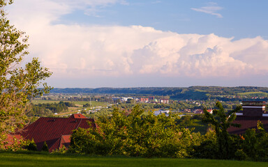 Breathtaking panoramic view of a vibrant landscape showcasing lush green hills and dramatic clouds...
