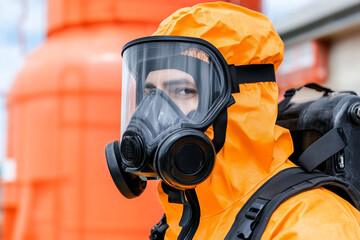 Worker in protective suit operates machinery in industrial facility