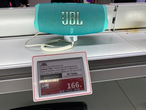 Palma De Mallorca, Spain - July 04, 2025: JBL Charge 4 portable Bluetooth speaker displayed on retail shelf with price tag, showcasing vibrant color and modern design for music lovers