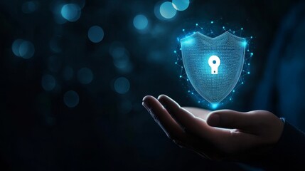 A glowing digital shield with a keyhole symbol floats above an open hand, symbolizing cybersecurity and data protection in a futuristic blue-toned setting.