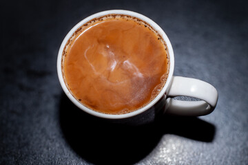 Detail of milk mixing in coffee drink, flat texture. Fresh beverages background