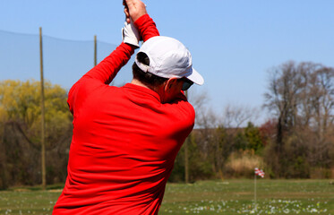 Golfer Practicing Swing at an Outdoor Driving Range