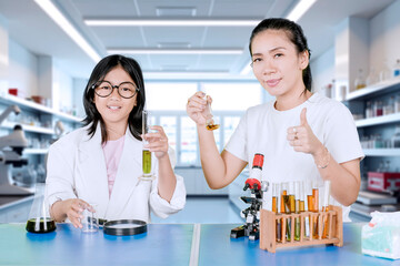 Mother and Daughter Conducting Science Experiment Together in Laboratory