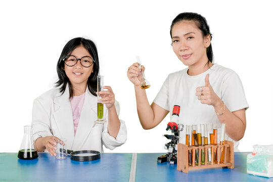 Happy Young Girl and Supportive Mother Doing Chemistry Experiment Together - Powered by Adobe