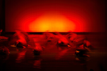 Dynamic Dance Performance with Vibrant Red Lighting