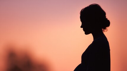Pregnant woman's silhouette with glowing baby outline against sunset, embodying maternal love and new beginnings