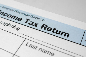 Close-up view of income tax return form. Financial document for filing annual taxes with detailed...