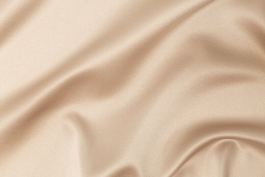 beige silk fabric background with folds
