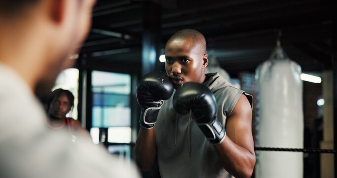 Boxing, fitness and coach with man in gym for mma training, sports athlete and self defense exercise. Personal trainer, learning and martial arts workout with people in ring for support and fight