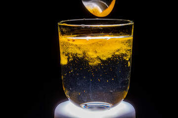 Close-up: Turmeric Particles Dispersing in Water