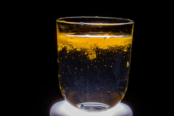 Close-up: Turmeric Particles Dispersing in Water