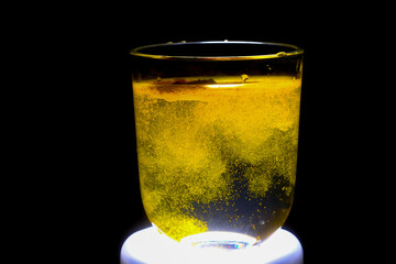 Close-up: Turmeric Particles Dispersing in Water