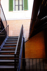 Modern black iron staircase with brick wall outdoor of vintage building exterior