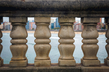 Coastal Balustrade Framing a Cityscape of Gijon and Beach. Asturias, Spain
