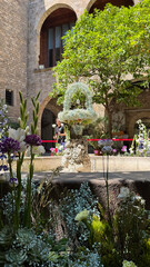 A festive tradition in Barcelona during Corpus Christi shows a flower-covered fountain with an egg gracefully dancing on a jet of water.