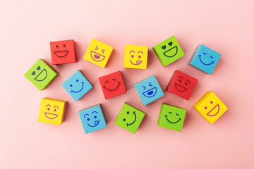 Group of Colourful Smiling Emoticon Diversity Face on Multi-colour Cube. Mind Mental Health. Happy Community. World Happiness, International Smiling Day. Table Top View