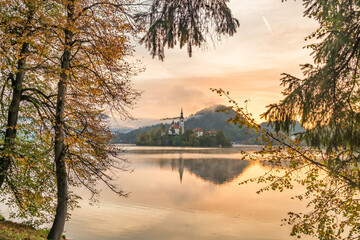 Lake Bled in autumn with island church and Bled Castle in Slovenia