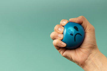 Hand Squeezing a ball used for emotional control and mental health practice, helping Stressed person reduce tension and improve mood