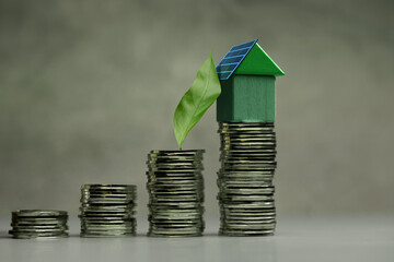 Green Solar cell House and Leaf on Coin Stack. Sustainable, Green investment, financial, eco-friendly economic growth