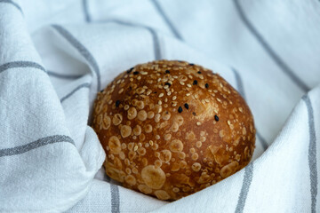 A small bun of white flour on a kitchen towel.