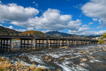 People in Togetsukyo bridge across river in autumn, Arashiyama, Kyoto