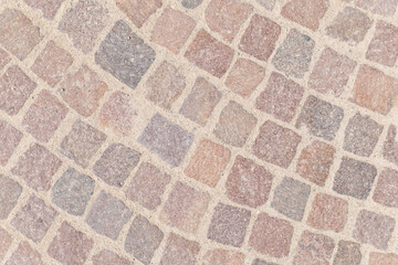 Cobblestone pathway glistening under soft sunlight in a serene outdoor setting