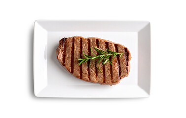 Grilled beef steak with rosemary on white rectangular plate, transparent background