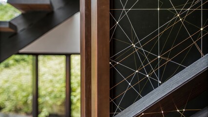 Modern interior design with a geometric string art installation on a window frame and a green outdoor view in the background.