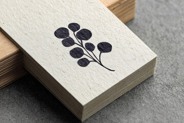 Minimalist botanical stamp mockup featuring simple black plant illustration on textured off white paper, perfect for branding, stationery, or eco friendly design inspiration