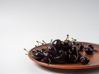 Sweet cherries with apricots isolated on white background cutout. Ripe berries closeup. Mix berries and fruits.