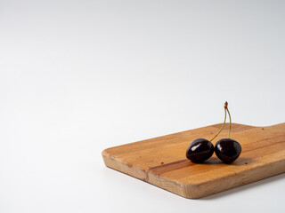 Sweet cherries with apricots isolated on white background cutout. Ripe berries closeup. Mix berries and fruits.