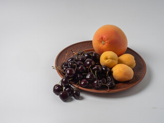 Sweet cherries with apricots isolated on white background cutout. Ripe berries closeup. Mix berries and fruits.