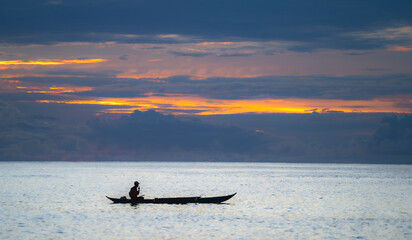 Silhouette fisherman on the top boat