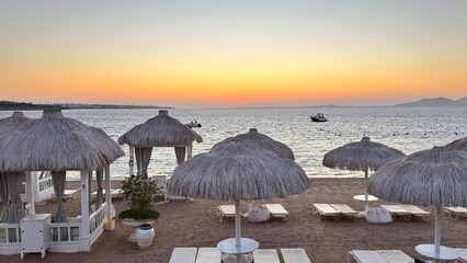 View of beach with beautiful sunset sky and boats.Tropical Seascape with a boat on sandy beach at...