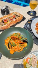 Served dining table.pizza.meat.shrimps salad avocado.Turkish dish featuring doner meat French fries shrimps skewers Variety of tasty cold snacks served