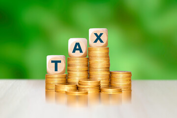 Rising stacks of gold coins topped with "TAX" blocks, symbolizing increasing tax burdens, financial growth, or economic concepts. Ideal for finance and business visuals.