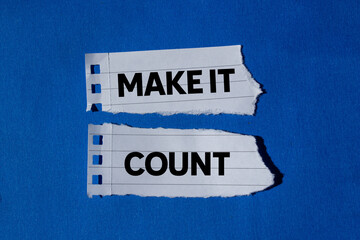 Make it count message written on ripped torn white paper pieces on blue background. Conceptual make...