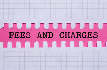 Fees and charges message written on ripped torn paper on pink background. Conceptual fees and...