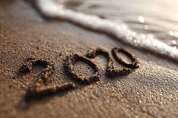 The word 2020 written in the sand on a beach
