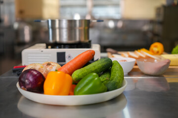 Ingredients for a fresh vegetable and egg sandwich are placed on a table in a modern kitchen.