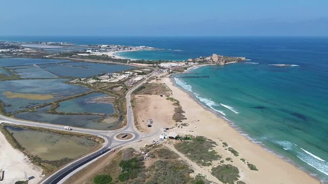 Aerial footage of Atlit and salty ponds, a coastal town located south of Haifa, Israel, Mediterranean sea. The Crusaders built the historical settlement of Atlit, also known as Chateau Pelerin